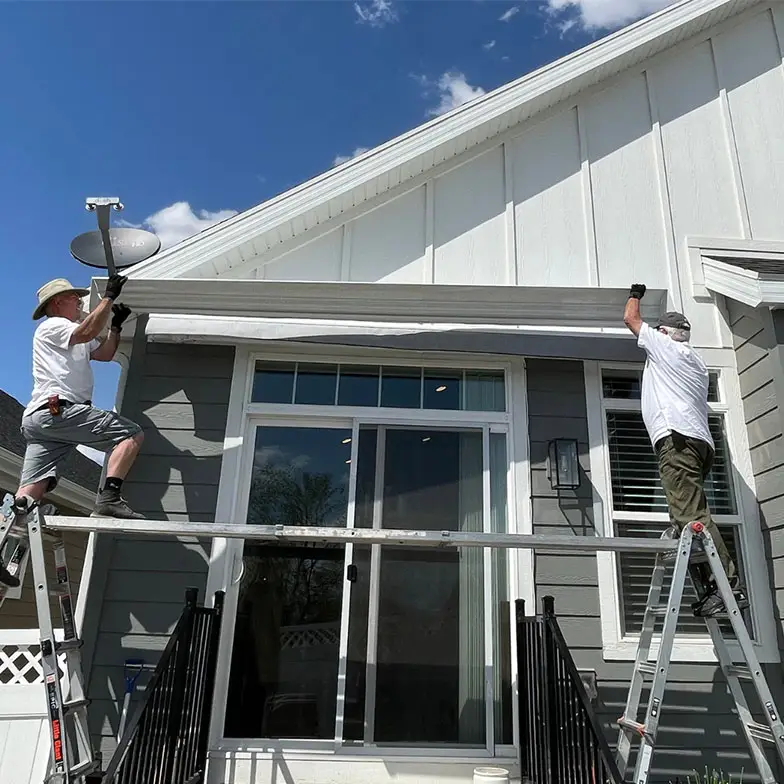 certified technicians installing retractable awning