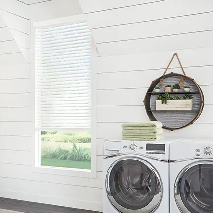 White retractable window shade in bright white room